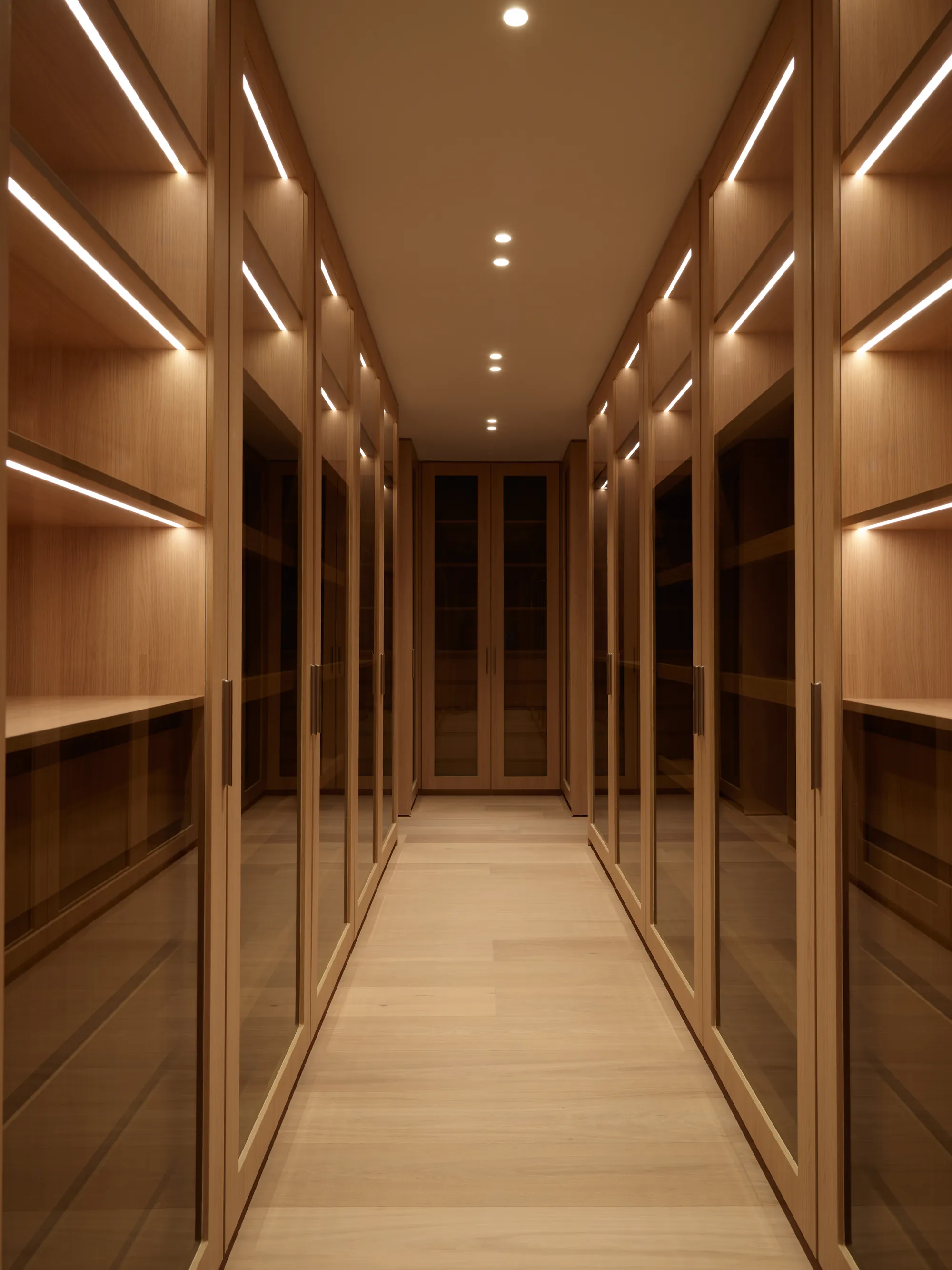 Hand-finished warm wall surfaces along a gallery corridor in the Ingraham residence by LUXOM